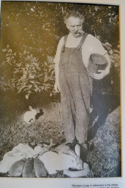 in his retirement, Mr. Longy pictured with his rabbits