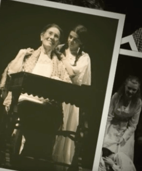 Liz sitting at a desk with Emma Suzik holding my hand from behind